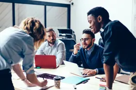 STOCK image: Creative team of young researchers and industry representatives working together