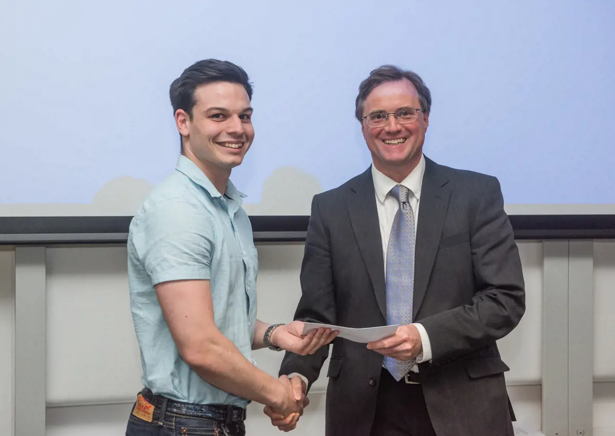 4th year student receiving his project poster prize at the lubbock lecture